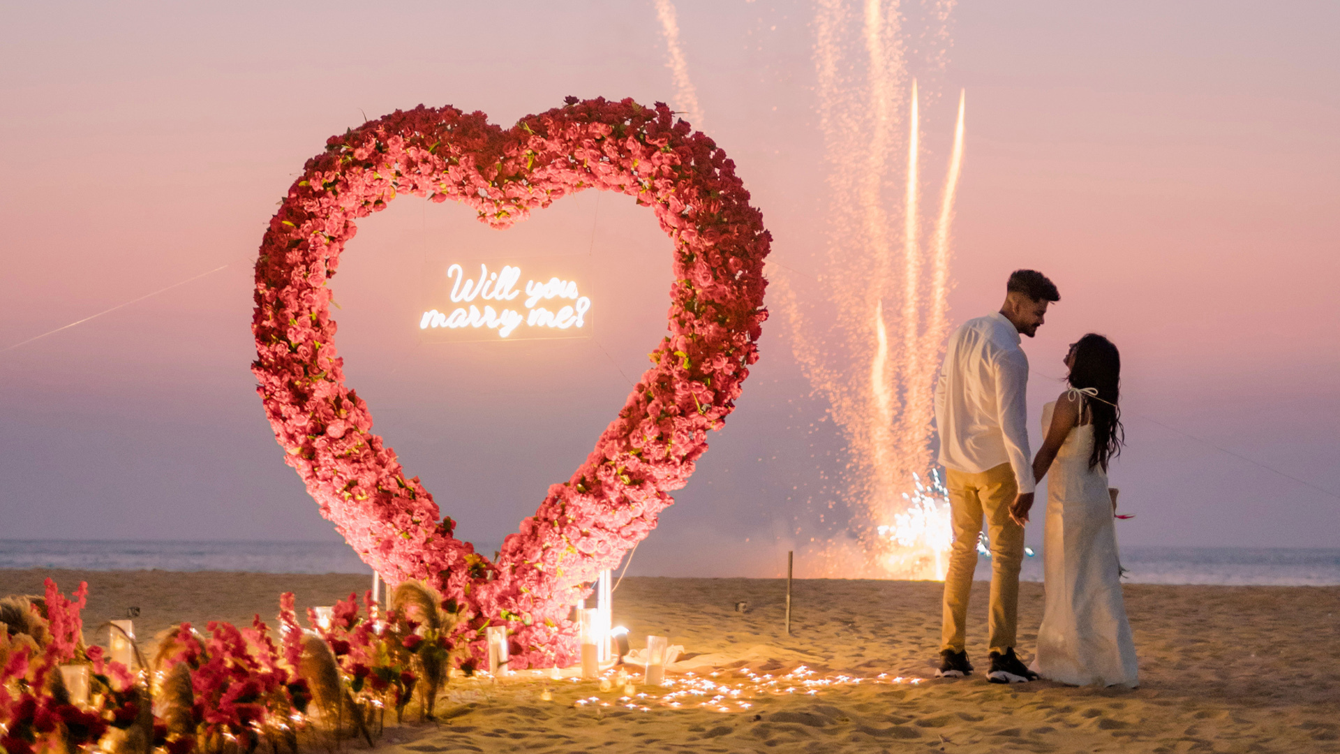 Romantic beach proposal with flower arch, "Will you marry me?" sign, fireworks, Sri Lankan matrimony 2024.
