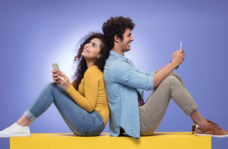 A man and woman seated side by side, looking at a laptop screen, possibly collaborating on a project or task, representing Mangala Kinkini, Mangala Yojana, Mangala Sewaya, Sri Lankan matrimony, Sri Lankan bride, and planning marriage proposals in Sri Lanka on Poruwa.lk | ශ්‍රී ලාංකීය මංගල යෝජනා.