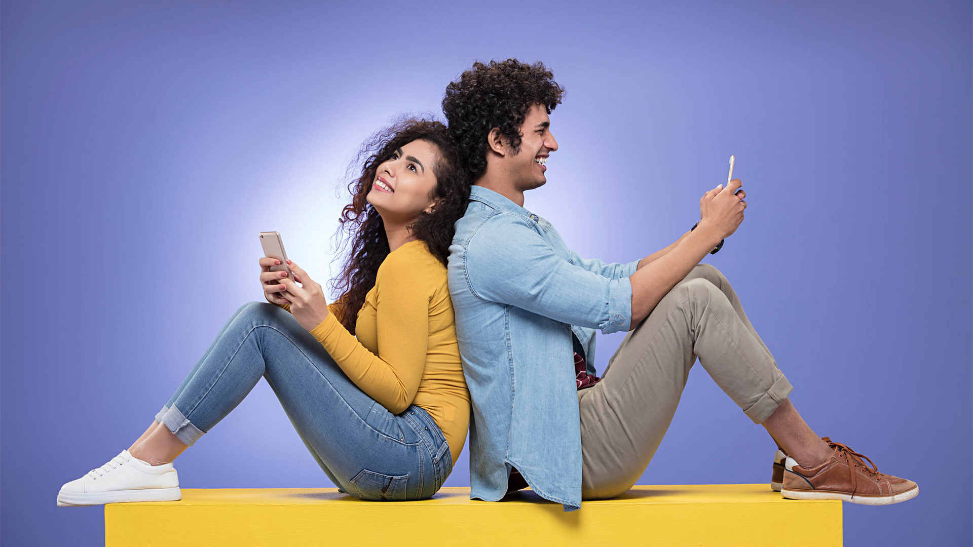 A man and woman seated side by side, looking at a laptop screen, possibly collaborating on a project or task, representing Mangala Kinkini, Mangala Yojana, Mangala Sewaya, Sri Lankan matrimony, Sri Lankan bride, and planning marriage proposals in Sri Lanka on Poruwa.lk | ශ්‍රී ලාංකීය මංගල යෝජනා.