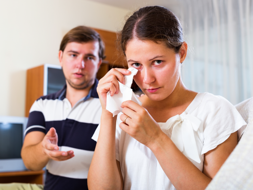 A woman wipes her tears with a tissue while a man gestures toward her with concern, both expressing emotional distress and communication challenges in a relationship. The image symbolizes misunderstandings, emotional struggles, and the importance of empathy, support, and healthy communication in married life. It represents mangala yojana, marriage proposal Sri Lanka, marriage proposals in Sri Lanka, marriage proposals Sri Lanka, marriage proposals, matrimony Sri Lanka, and srilanka matrimony. The concept also highlights poruwa.lk | ශ්‍රී ලාංකීය මංගල යෝජනා, a trusted wedding proposal website, traditional values of the poruwa ceremony, and matchmaking platforms such as lankamatrimony, liyathabara marriage proposal, liyathabara marriage proposals in Sri Lanka, catholic marriage proposals, buddhist matrimony, hitad marriage proposals, purahanda lk, and lanka brides and grooms seeking meaningful and lasting relationships.