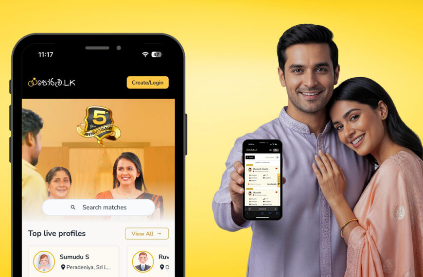 A smiling couple in traditional attire holds a smartphone showing a dating and wedding proposal website app celebrating its 5th anniversary, representing mangala yojana, matrimony Sri Lanka, SriLanka matrimony, and marriage proposals in Sri Lanka, including Poruwa.lk | ශ්‍රී ලාංකීය මංගල යෝජනා, poruwa ceremony services, LankaMatrimony, hitad marriage proposals, Catholic marriage proposals, Buddhist matrimony, Liyathabara marriage proposals in Sri Lanka, Lanka brides and grooms, and Purahanda LK platforms for finding the ideal marriage proposal Sri Lanka.