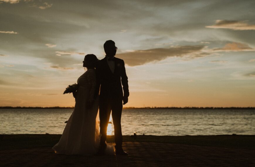 A professional wedding photographer in Orlando, Florida capturing a couple’s romantic moments with a scenic outdoor backdrop, perfect for wedding photography memories.