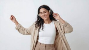 A joyful woman with long dark hair wearing headphones and dancing peacefully, representing modern marriage proposals in Sri Lanka, matrimony Sri Lanka, Lanka brides and grooms, wedding proposal website Mangala Yojana, Poruwa.lk | ශ්‍රී ලාංකීය මංගල යෝජනා, Buddhist matrimony, Catholic marriage proposals, Liyathabara marriage proposals in Sri Lanka, and traditional Poruwa ceremony.