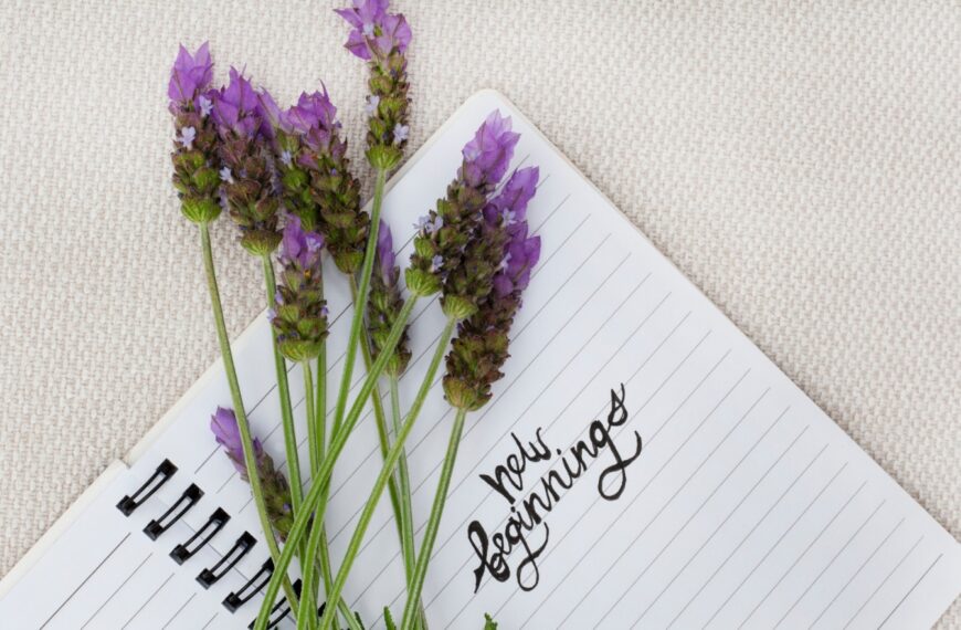Lavender flowers around a notepad with Happy Birthday written in the center, elegant floral birthday greeting.