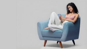 A Sri Lankan woman using her phone to browse a trusted wedding proposal website for marriage proposals in Sri Lanka, exploring Poruwa.lk | ශ්‍රී ලාංකීය මංගල යෝජනා and matrimony services.