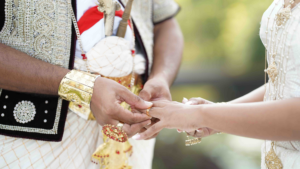 A man and woman in traditional attire hold hands, symbolizing unity and cultural heritage.