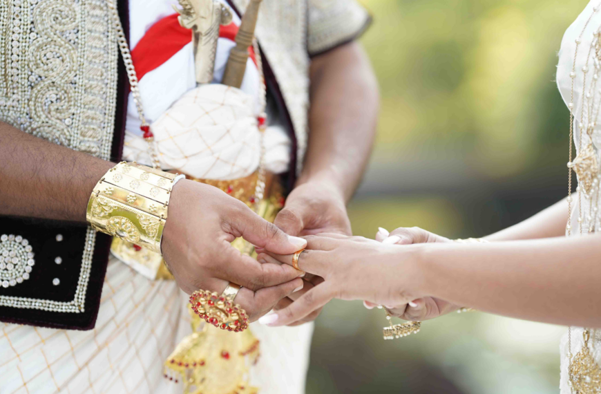 A man and woman in traditional attire hold hands, symbolizing unity and cultural heritage.