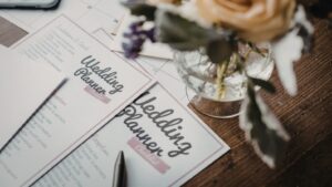 Wedding planner notebook and pen on a wooden table, used for planning Sri Lankan weddings and marriage proposals on Poruwa.lk.