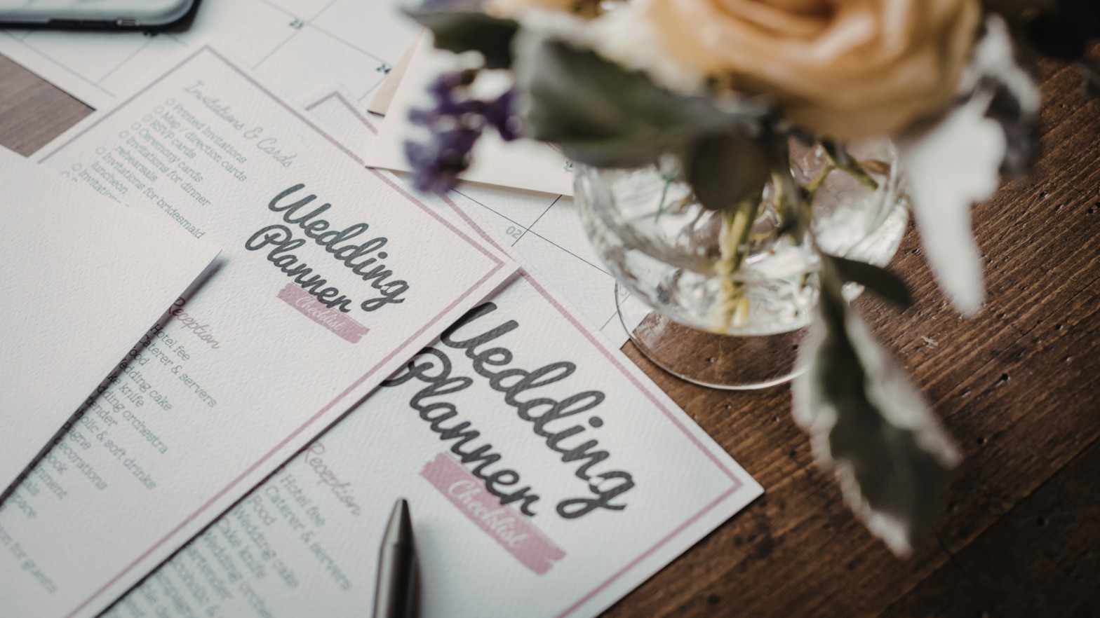 Wedding planner notebook and pen on a wooden table, representing organized planning for Sri Lankan weddings and marriage proposals, including mangala yojana traditions and matrimony Sri Lanka services featured on Poruwa.lk | ශ්රී ලාංකීය මංගල යෝජනා, a trusted wedding proposal website for Lanka brides and grooms, Buddhist matrimony, and Catholic marriage proposals.