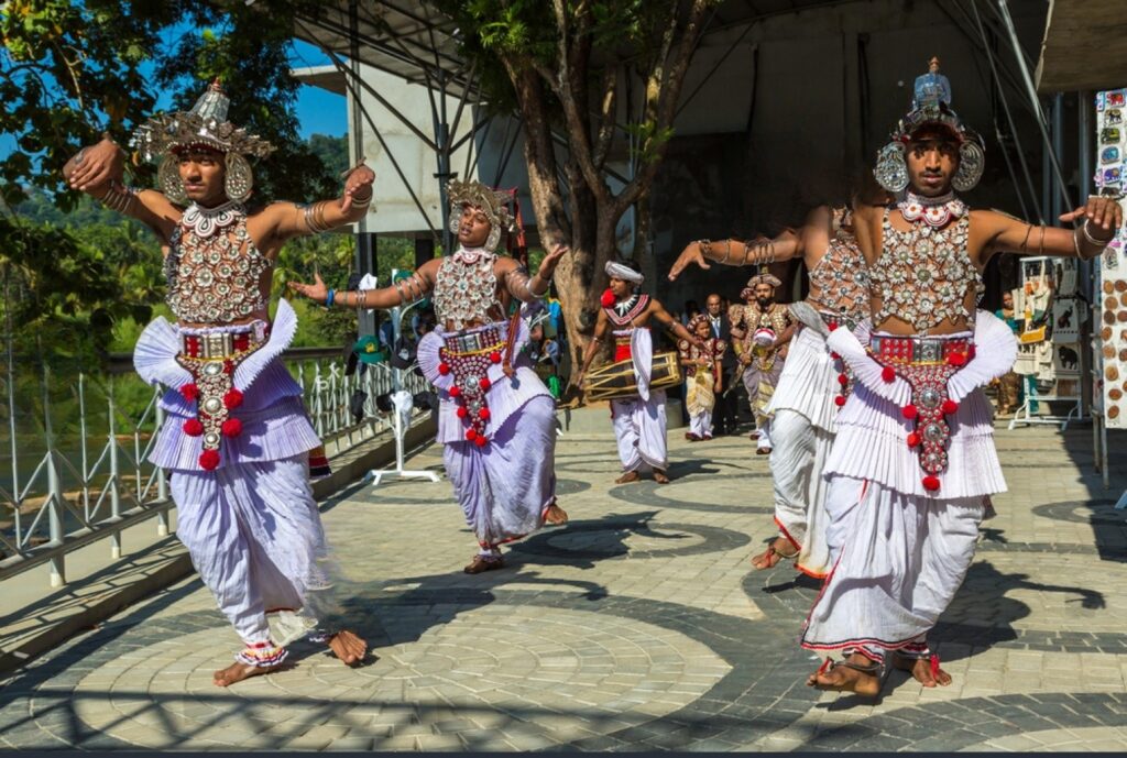 Traditional Sri Lankan dancers in ornate costumes perform a vibrant cultural dance during a traditional poruwa ceremony celebration, representing Sri Lankan wedding traditions, mangala yojana customs, and marriage proposals in Sri Lanka featured on Poruwa.lk | ශ්‍රී ලාංකීය මංගල යෝජනා, a trusted wedding proposal website for matrimony Sri Lanka, Sri Lanka matrimony, Buddhist matrimony, Catholic marriage proposals, Lanka brides and grooms, Liyathabara marriage proposals in Sri Lanka, Hitad marriage proposals, Purahanda.lk, and LankaMatrimony.