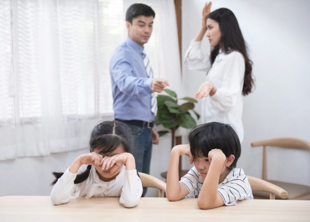 A family sits together around a table with their hands on their heads, expressing surprise, concern, or stress while discussing an important family matter. The image symbolizes communication challenges, relationship conflicts, and the importance of understanding within families and married life. It represents mangala yojana, marriage proposal sri lanka, marriage proposals in sri lanka, marriage proposals sri lanka, marriage proposals, matrimony sri lanka, and srilanka matrimony. The concept also highlights poruwa.lk | ශ්‍රී ලාංකීය මංගල යෝජනා, a trusted wedding proposal website, traditional values of the poruwa ceremony, and matchmaking platforms including lankamatrimony, liyathabara marriage proposal, liyathabara marriage proposals in sri lanka, catholic marriage proposals, buddhist matrimony, hitad marriage proposals, purahanda lk, and lanka brides and grooms seeking strong and lasting relationships.