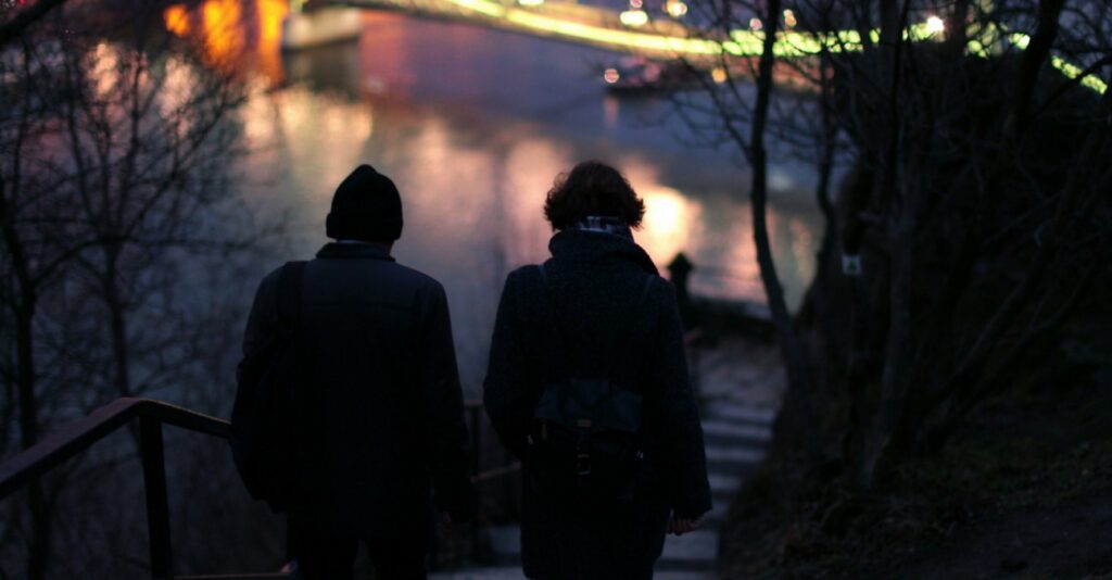 A Sri Lankan couple walking together down a hill at night with an illuminated river in the background, symbolizing love, companionship, and a shared journey through life. Represents meaningful relationships and future connections for couples exploring marriage proposals Sri Lanka, mangala yojana, and matrimony Sri Lanka through Poruwa.lk | ශ්රී ලාංකීය මංගල යෝජනා, a trusted wedding proposal website for lanka brides and grooms, srilanka matrimony, buddhist matrimony, catholic marriage proposals, and liyathabara marriage proposals in Sri Lank