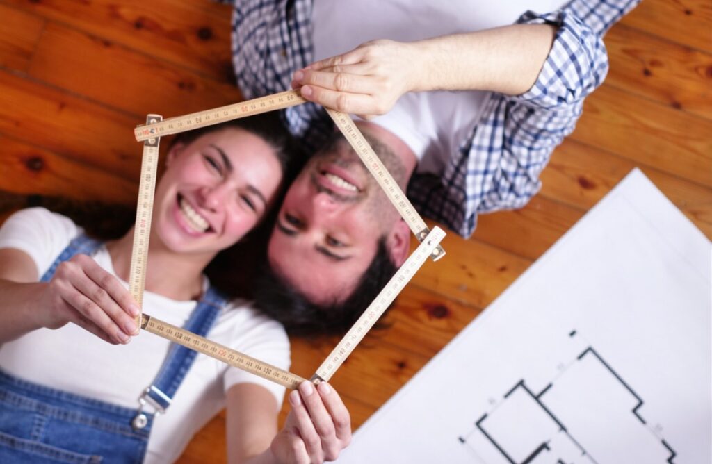 A Sri Lankan couple collaboratively holding a wooden house frame, symbolizing teamwork, partnership, and building a strong future together. Represents love, commitment, and life goals for couples exploring marriage proposals Sri Lanka, mangala yojana, and matrimony Sri Lanka through Poruwa.lk | ශ්‍රී ලාංකීය මංගල යෝජනා, a trusted wedding proposal website for lanka brides and grooms, srilanka matrimony, buddhist matrimony, catholic marriage proposals, and liyathabara marriage proposals in Sri Lanka.