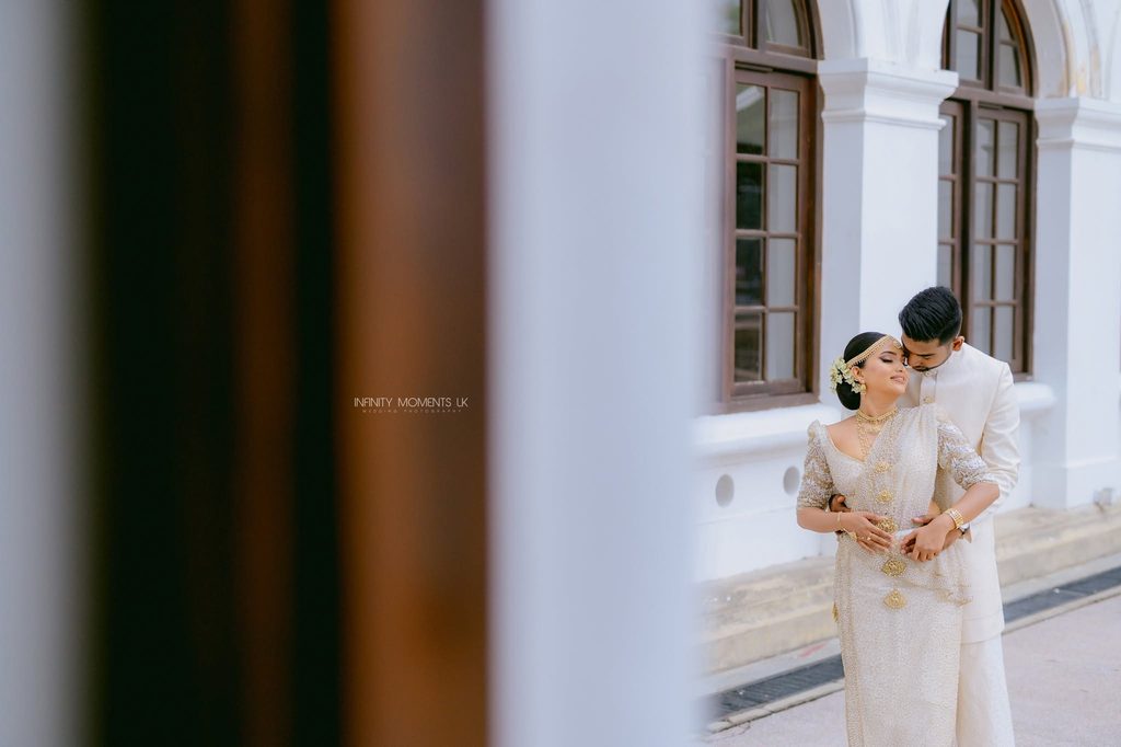 A Sri Lankan wedding photographer captures a couple exchanging vows during a vibrant outdoor ceremony surrounded by lush greenery, highlighting mangala yojana traditions, marriage proposals in Sri Lanka, matrimony Sri Lanka, srilanka matrimony, lanka brides and grooms, Buddhist matrimony, Catholic marriage proposals, liyathabara marriage proposals in Sri Lanka, and Poruwa.lk | ශ්‍රී ලාංකීය මංගල යෝජනා.