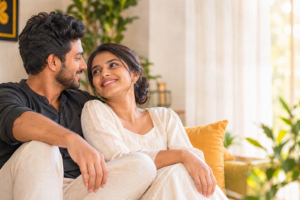 Smiling couple cuddles on a sofa in a sunlit living room, sharing a warm moment that represents marriage proposals, mangala yojana, මංගල යෝජනා, mangala sewaya, marriage proposals in Sri Lanka, marriage proposals Sri Lanka, matrimony Sri Lanka, srilanka matrimony, lankamatrimony, mangala ads.lk, Silumina marriage proposals, Sunday Observer marriage proposals, liyathabara marriage proposals in Sri Lanka, and Catholic marriage proposals.