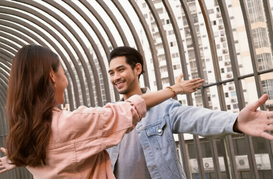 A smiling man and woman standing together in front of a modern building, dressed in casual attire, representing companionship, trust, and meaningful relationships through mangala yojana, marriage proposals in Sri Lanka, matrimony Sri Lanka, srilanka matrimony, and Sri Lankan marriage proposals for compatible life partners.